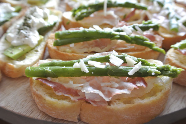 Bruschetta with green asperses and Italian ham